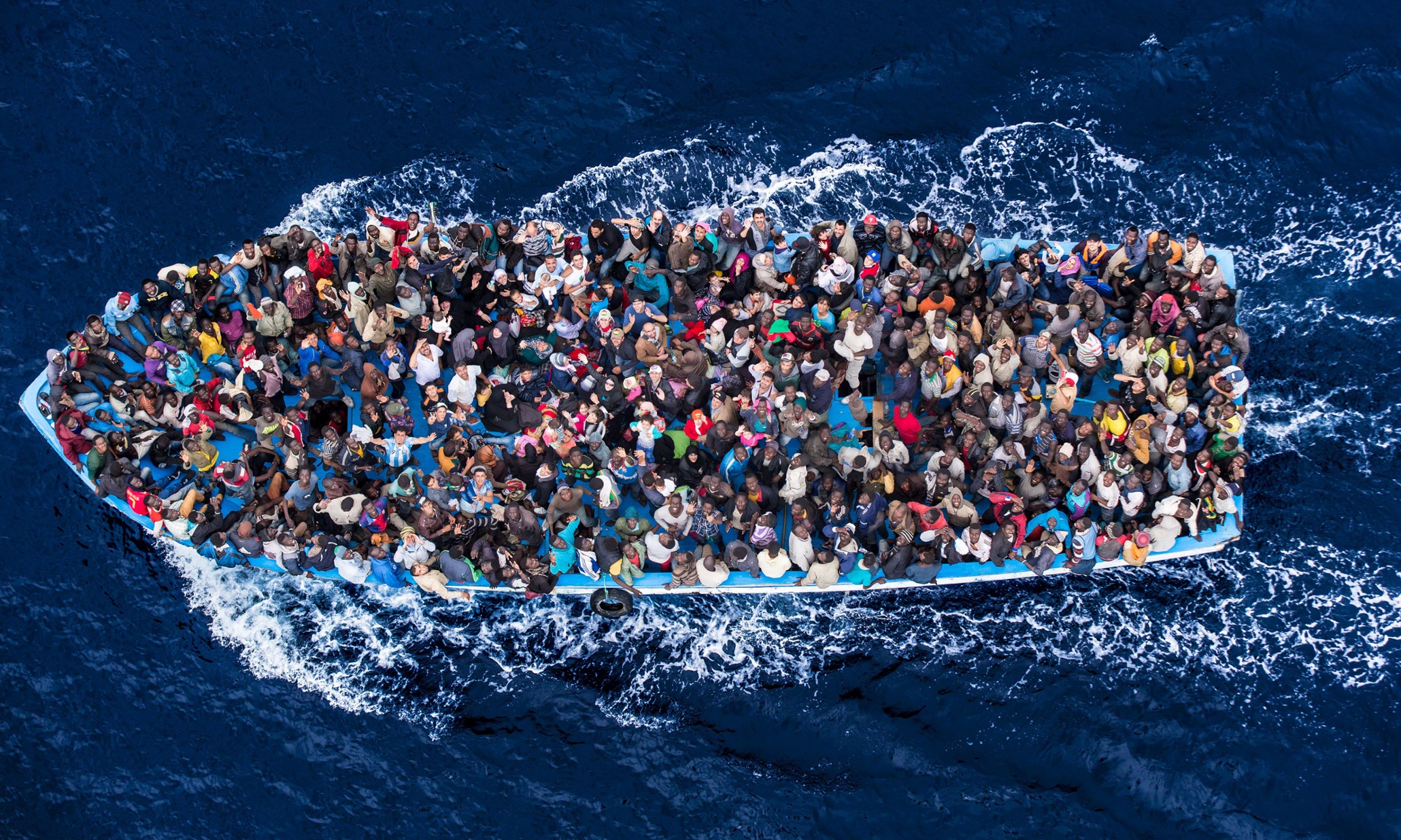 African asylum seekers rescued off boats and taken aboard an Italy navy ship, June 8, 2014. Photographer Massimo Sestini accompanied the Italian navy on its rescue missions earlier this month, offering a rare up-close glimpse of the men, women and children who make the dangerous trip to start a new life. Eight months after a boat carrying hundreds of migrants sank off the coast of Lampedusa, killing more than 360 people and spurring an international outcry, the flow of migrants risking the perilous sea journey to Europe shows no signs of letting up. Already this year, the number of migrants arriving by boat on Italy’s shores has surpassed 40,000, the total number of migrants that arrived in 2013. Earlier this month, Italy said it rescued some 5,200 people in the span of just four days. Officials there warn that many more will die without broader support from across Europe. Tens of thousands of refugees and migrants make the journey to Europe annually, departing from dozens of countries in Africa and the Middle East, according to the European Parliament. In recent years, Syrians fleeing the civil war in their country have joined the ranks of Eritreans, Sudanese and Somalis looking for a better life, the UN said in April. Credit: Massimo Sestini / eyevine For further information please contact eyevine tel: +44 (0) 20 8709 8709 e-mail: info@eyevine.com www.eyevine.com